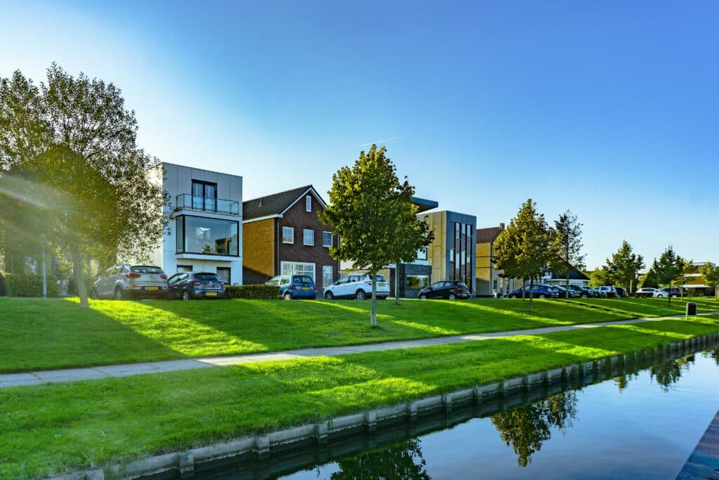 Modern houses beside a calm canal.